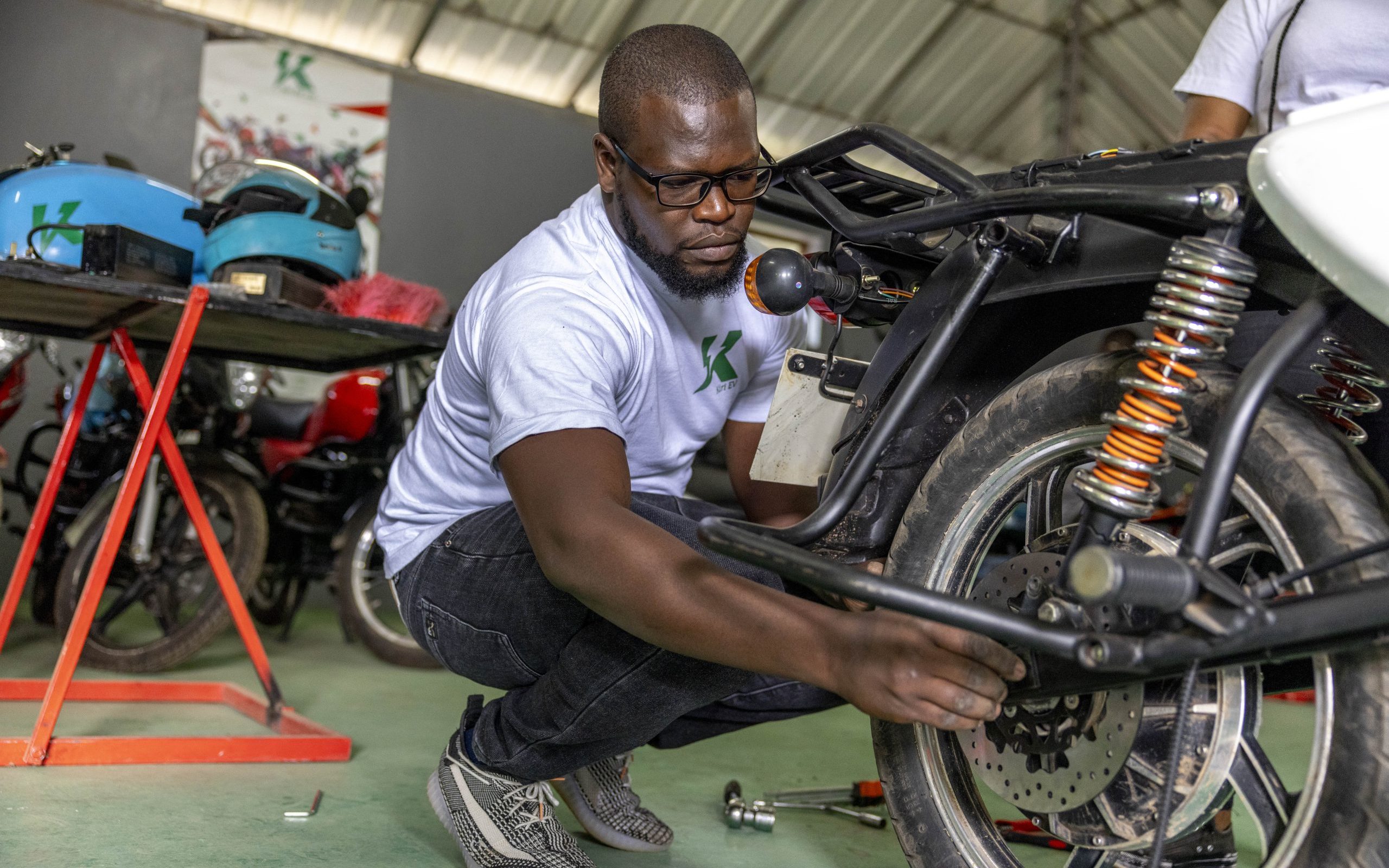 Mechanic working on electric motorcycle